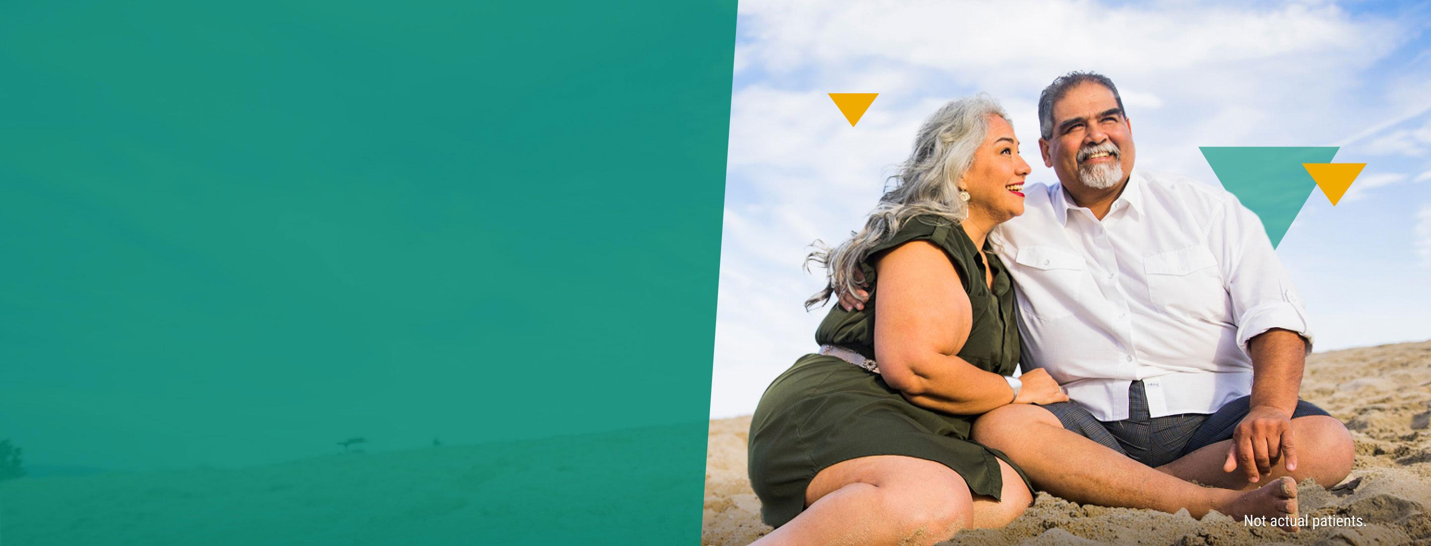 Middle-Aged Couple Sitting in the Sand at the Beach LOKELMA Homepage Banner