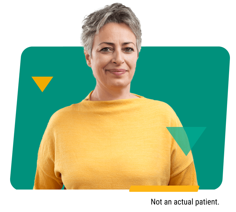 Woman With Short Gray Hair Smiling in A Yellow Top